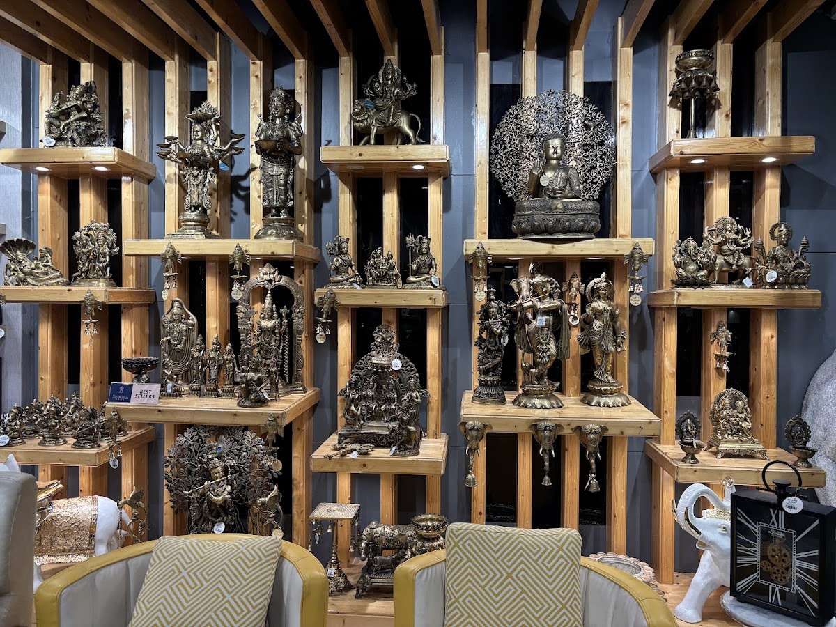 Wall of antique brass idols at Armonia